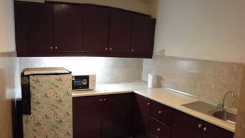 Family Suite, 2 Bedrooms, City View | Private kitchen | Fridge, microwave, dishwasher, dining tables