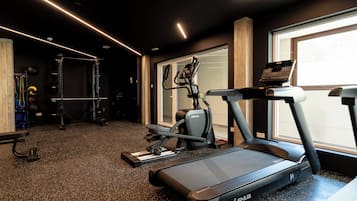 A gym with treadmills, a weight bench, and exercise equipment.