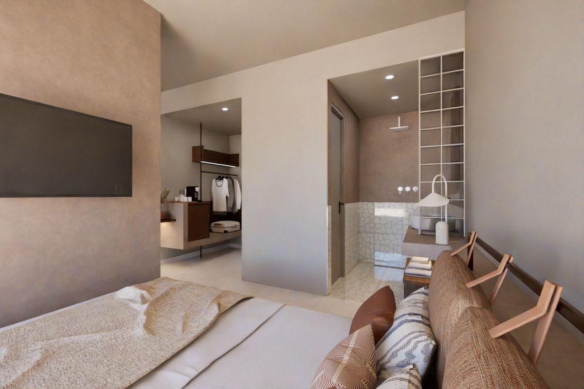 A modern bedroom with a large bed, a bedside table, a wardrobe, and a bathroom visible through an open door.