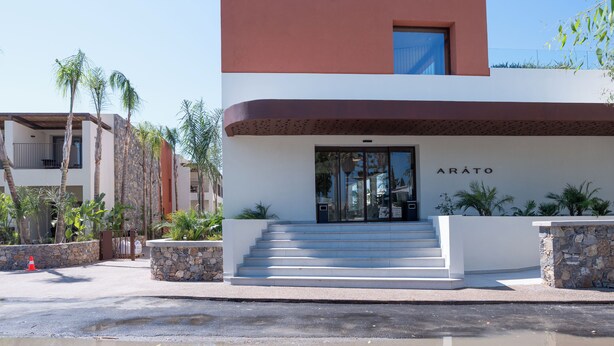 A modern building with a flat roof, a set of stairs leading to the entrance, and the name 'ARATO' displayed above the door. - ARATO by E•GEO, Adults Only (Kos)