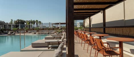 Seasonal outdoor pool, open 9:00 AM to 8:00 PM, pool umbrellas