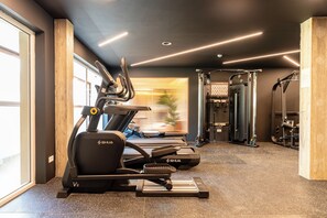 A gym with treadmills, a stationary bike, and weightlifting equipment. - ARATO by E•GEO, Adults Only (Kos)