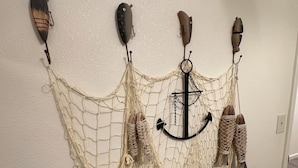 A wall with a decorative net and various fishing-related items. - New! Aurora Viewing, 3 mins from airport, Prime Location (Fairbanks)