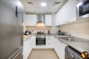 Luxury Apartment, Balcony, City View | Private kitchen | Full-size fridge, microwave, oven, stovetop
