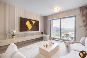 Luxury Apartment, Balcony, City View | Living area | 65-inch Smart TV with satellite channels