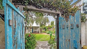 A rustic wooden gate leading to a stone pathway. - Saltwood: Yallingup Garden Sanctuary by the Sea (Yallingup)