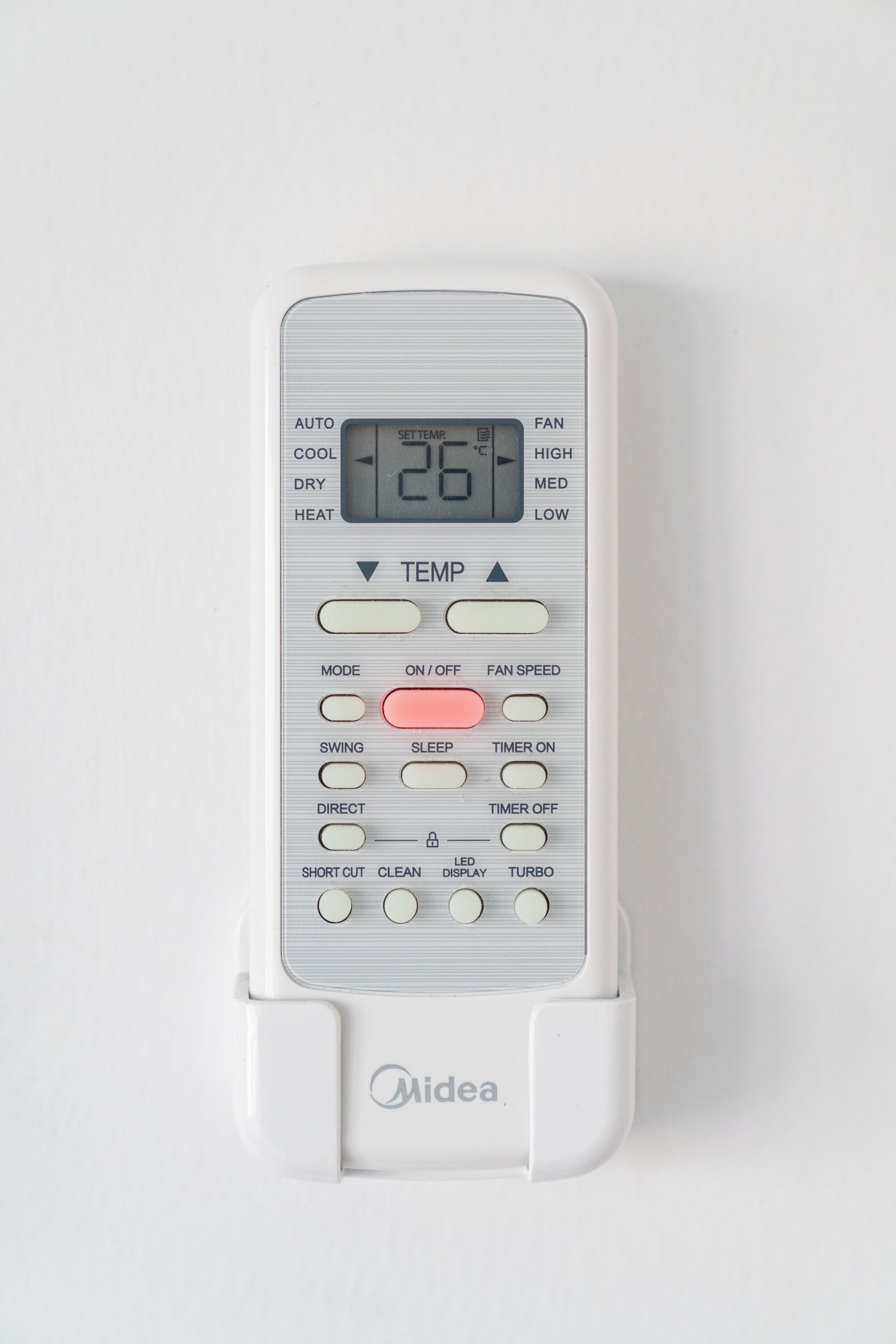 A white Midea air conditioner unit with a digital display, control buttons, and a brand logo.