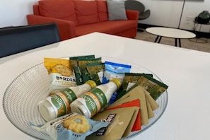 A dining table with a glass bowl containing food items and a bottle of milk. - 7VH Virginia House, 31 Bloomsbury Way by City Living London (London)