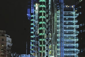 A high-rise building with multiple floors, illuminated by internal lighting. - 7VH Virginia House, 31 Bloomsbury Way by City Living London (London)