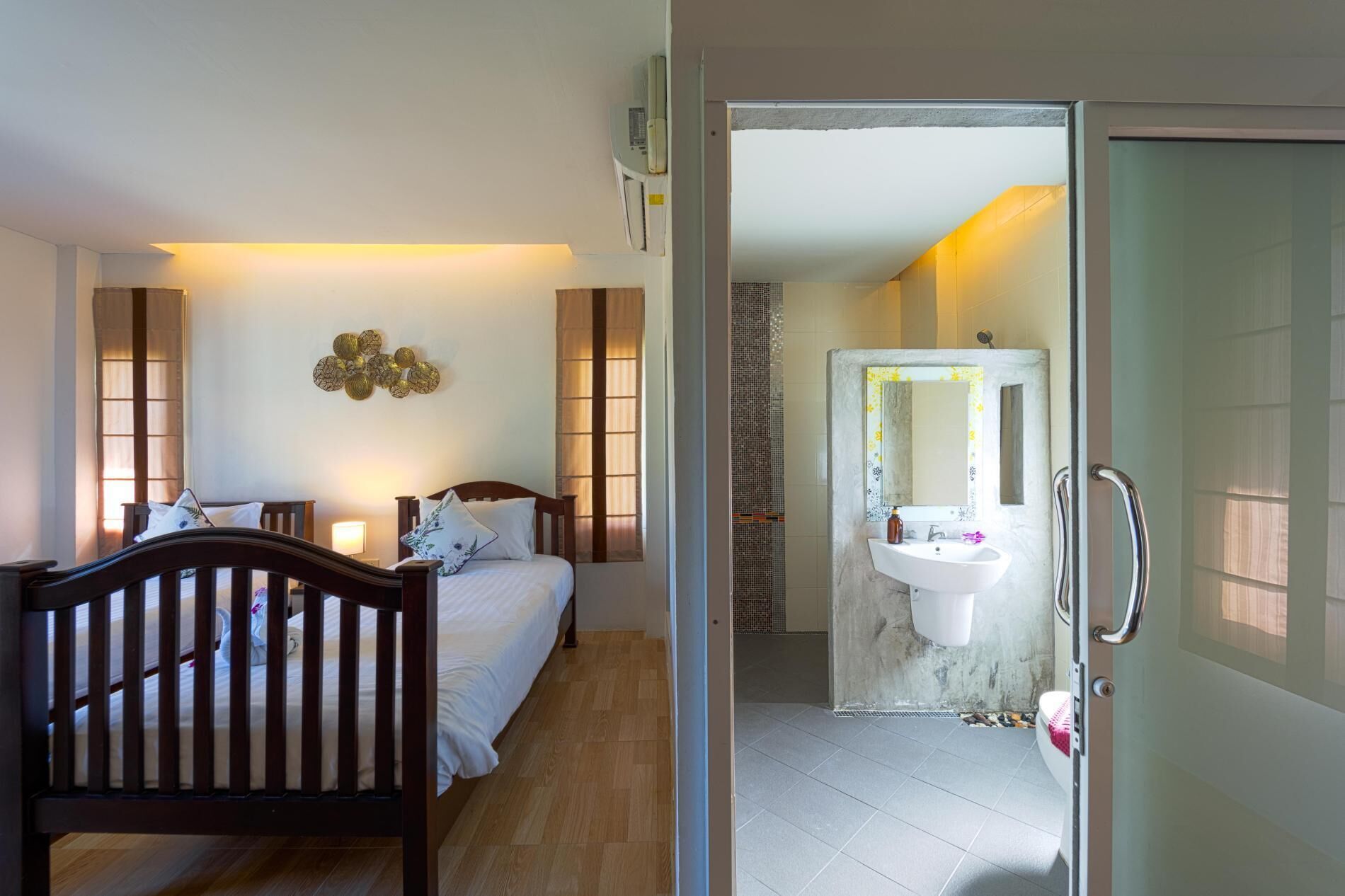 A bedroom with a wooden bed, a bedside table, and a wall-mounted decorative piece.