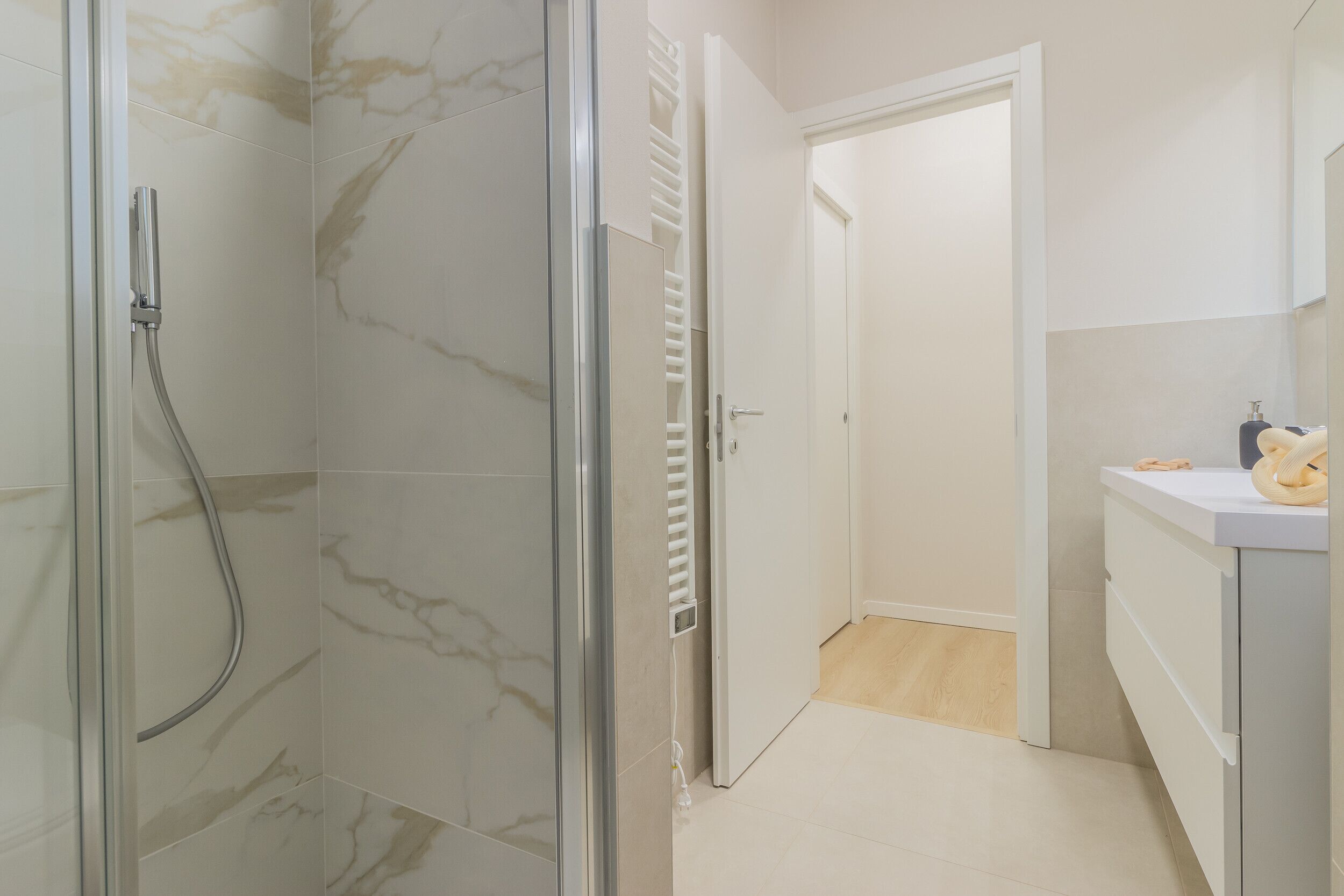 A bathroom with a shower, a toilet, and a sink.