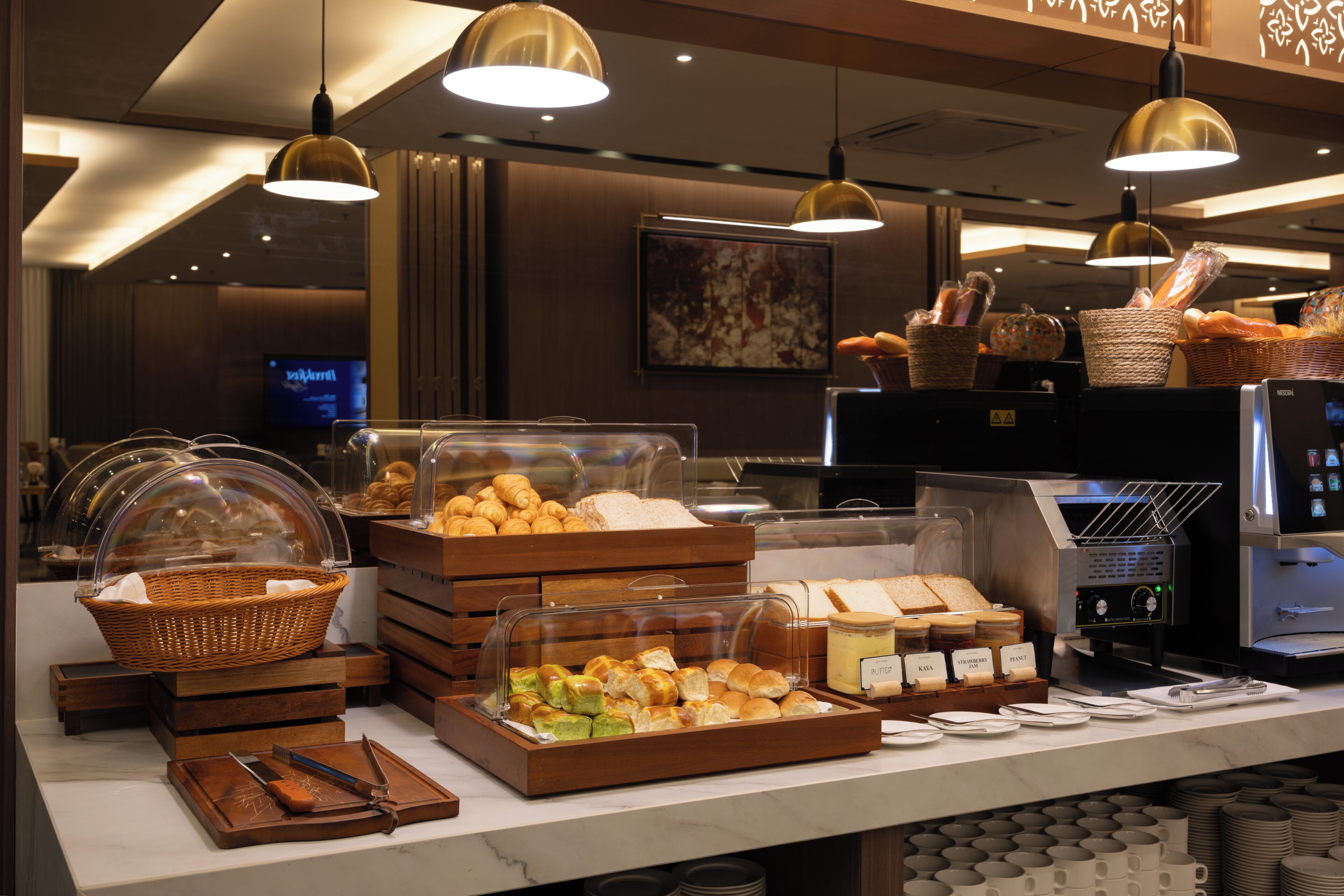 A buffet with various food items, baskets, and a coffee machine.