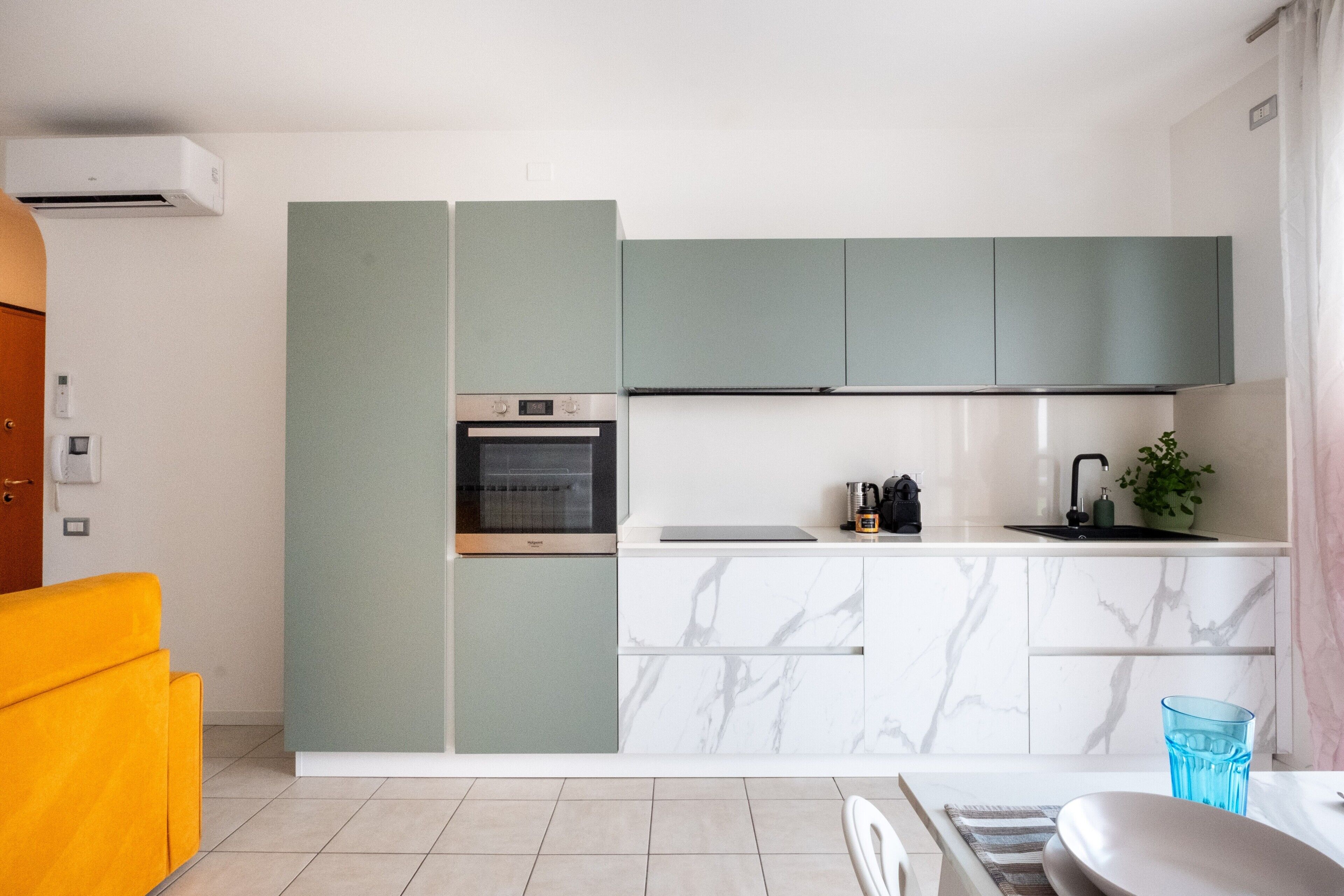 A modern kitchen with a built-in oven, a sink, and a countertop.