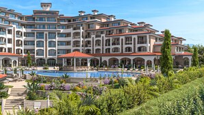 A multi-story hotel with a swimming pool, outdoor seating, and lush landscaping. - Sanders Solemare - Super Studio With Balcony (Pomorie)