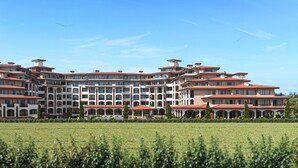A large, multi-story hotel with a red-tiled roof and multiple balconies. - One Bedroom Apartment With Balcony and Seaview (Pomorie)