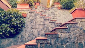 A multi-level stone staircase with red steps leading to a building with balconies. - Rooms within 15 minutes' drive of Cinque terre station and the sea (Vezzano Ligure)