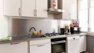 A modern kitchen with stainless steel appliances, a gas stove, a built-in oven, and a dishwasher.