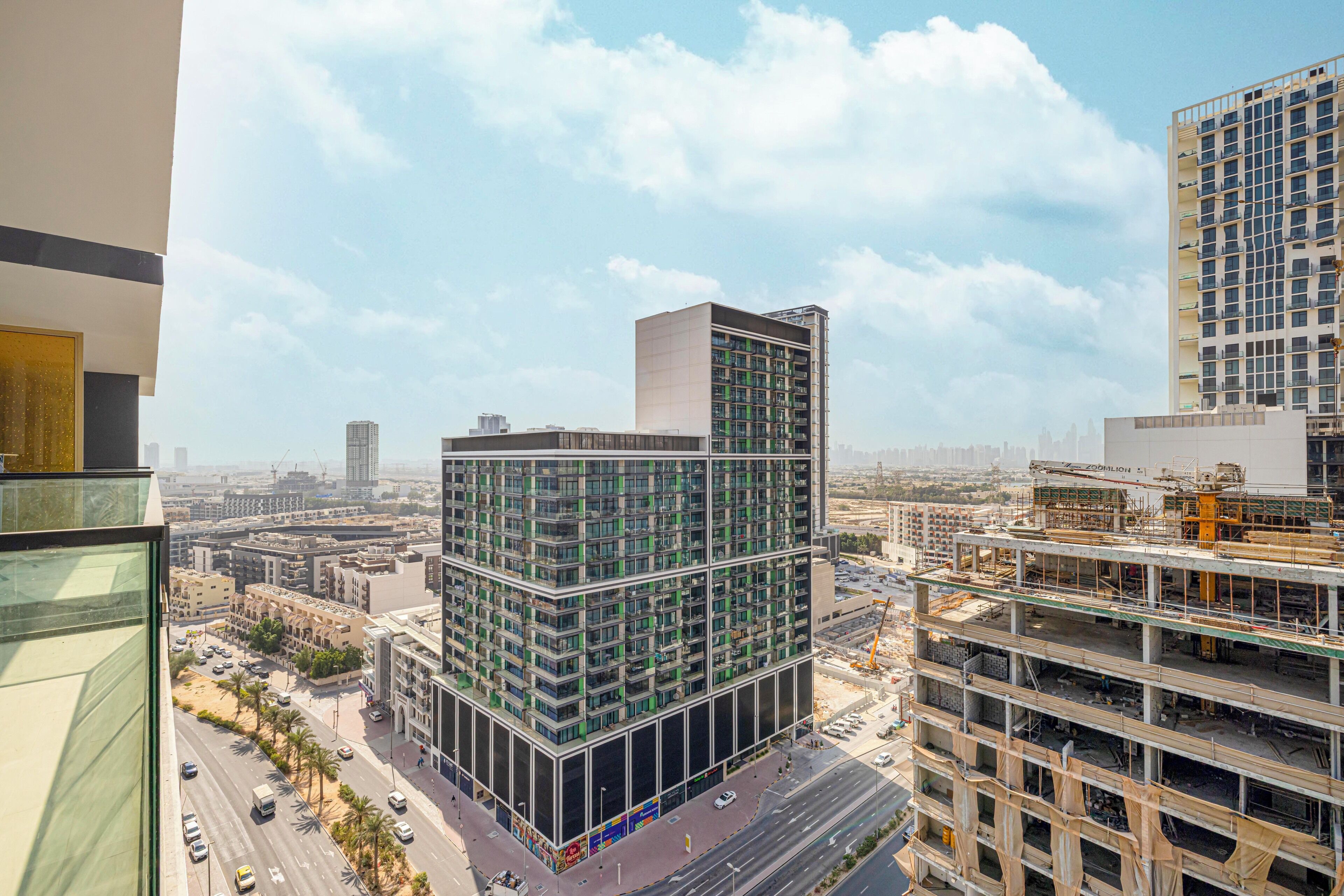 A high-rise building with multiple floors, surrounded by other buildings and a busy street.