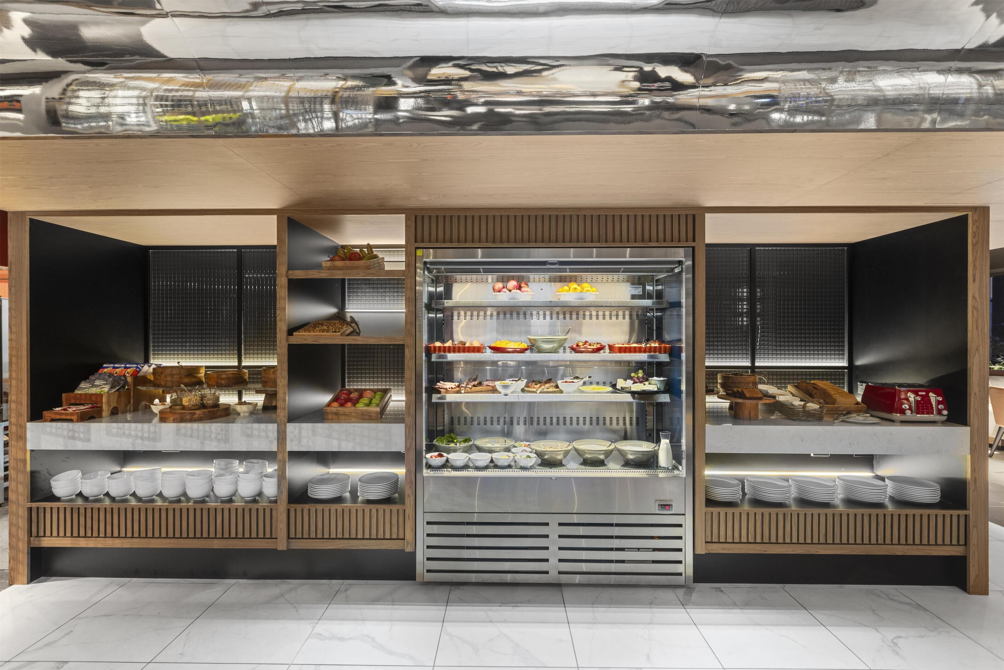 A modern buffet setup with multiple food stations and a variety of dishes.