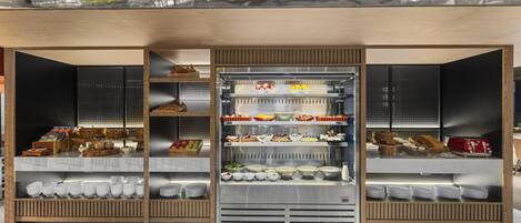 A modern buffet setup with multiple food stations and a variety of dishes.