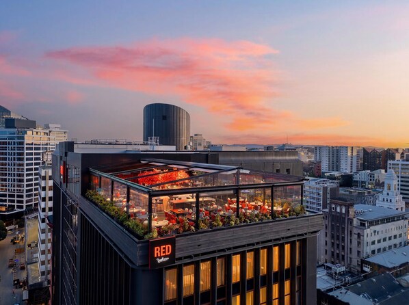 A rooftop terrace with outdoor seating and a view of the cityscape.