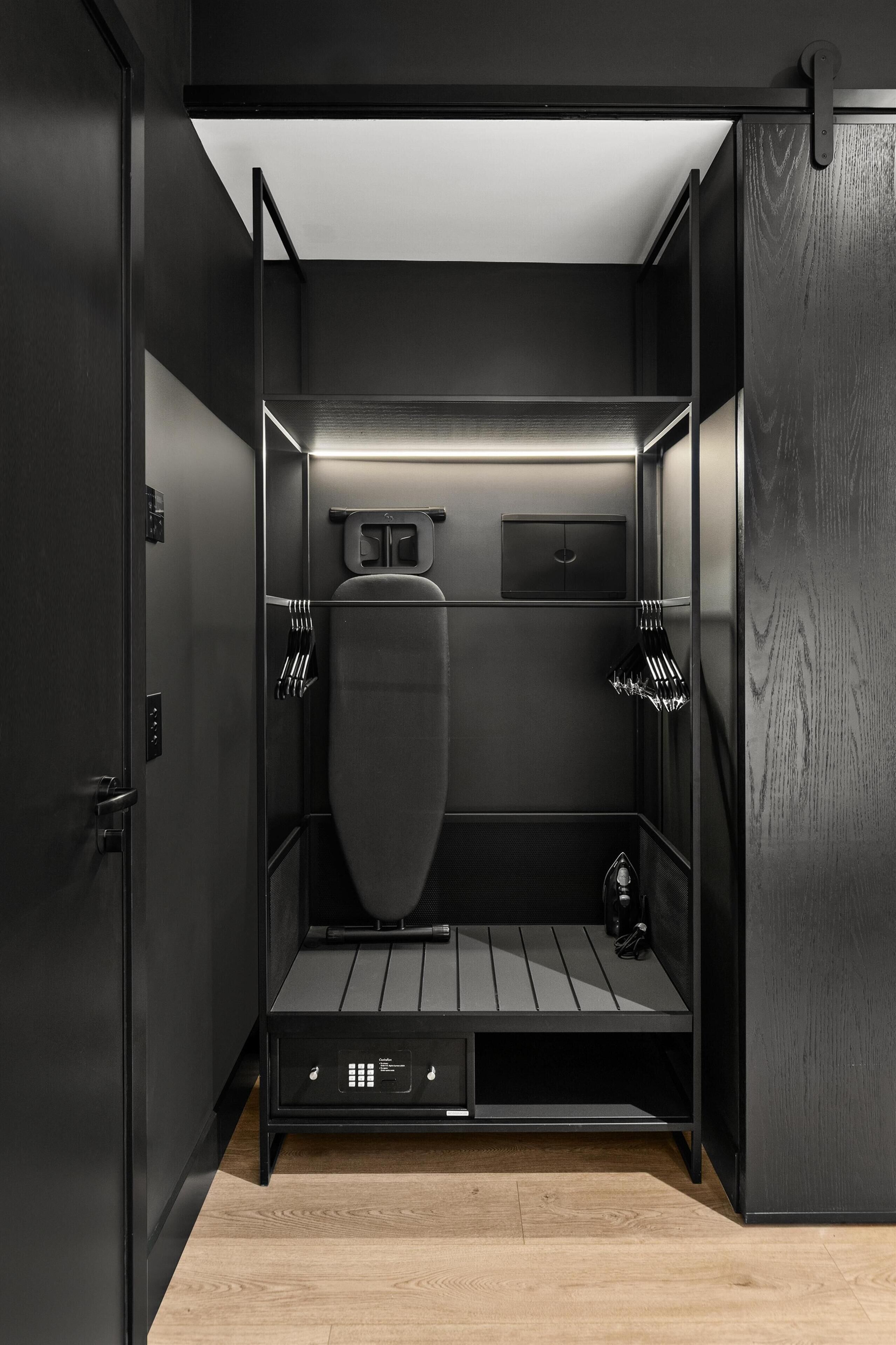 A compact, modern bathroom with a sleek design, featuring a toilet, sink, and storage compartments.
