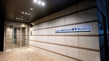 A station with a tiled floor and a sign reading "Liens-REGALO Station".