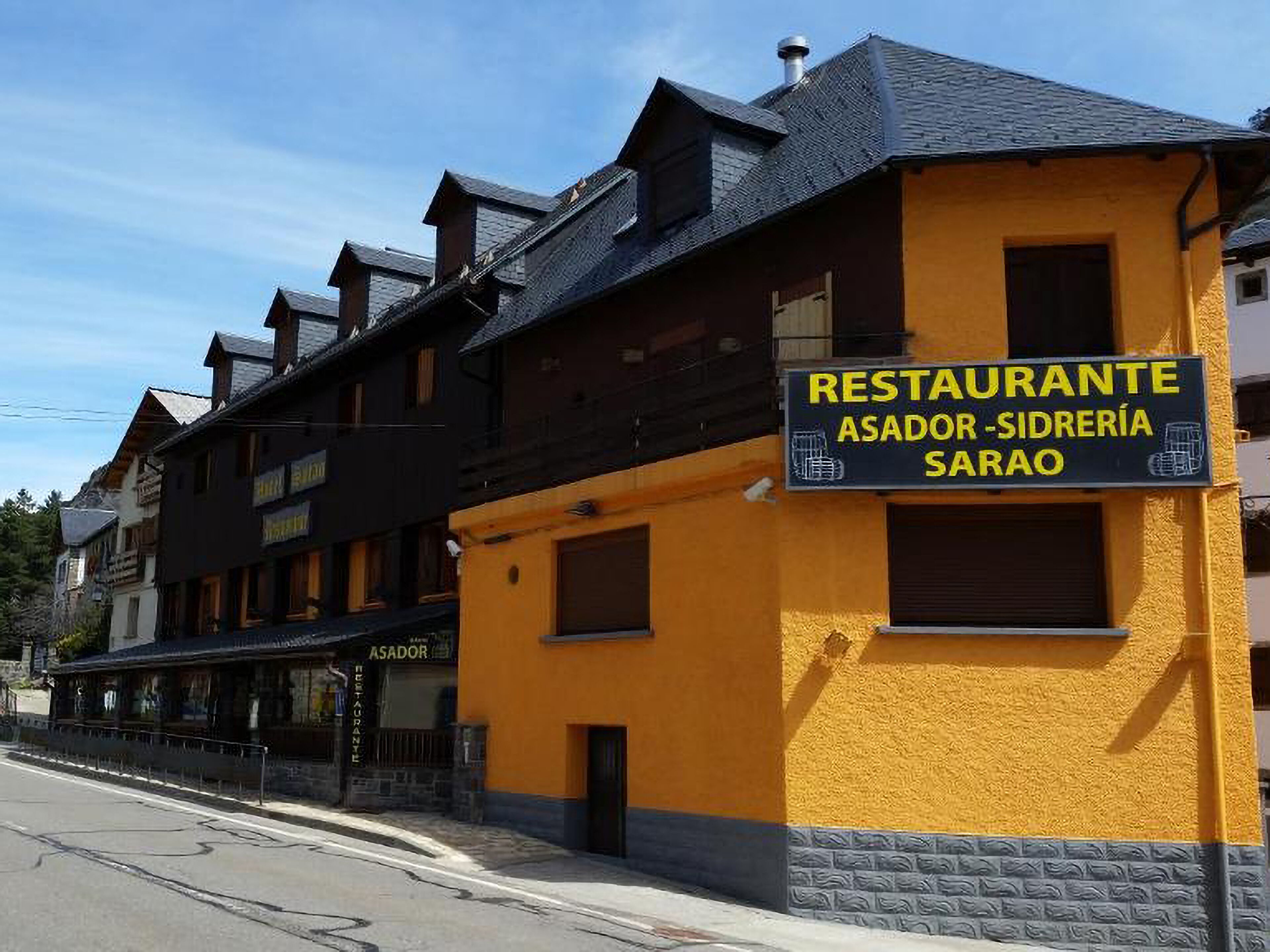 A building with a sign for 'RESTAURANTE ASADOR - SIDRERÍA SARAO'.