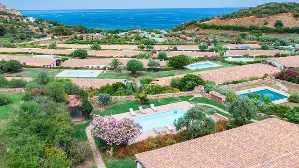 A coastal resort with multiple swimming pools, lush gardens, and terraced buildings. - Villa 'Casa Joy' with Sea View, Wi-Fi and Air Conditioning (Tertenia)