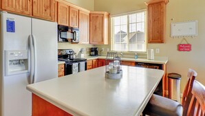 A kitchen with wooden cabinets, a refrigerator, a microwave, and a coffee maker. - Park City Area Lodge: 9 Mi to Timber Lakes (Heber City)