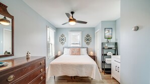 A bedroom with a bed, dresser, nightstands, and a ceiling fan. - Walk to Beach & Boardwalk: Ocean City Haven! (Ocean City)