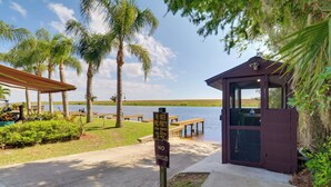 A private property entrance with a sign indicating no vehicles allowed, surrounded by palm trees and a body of water. - Unwind Poolside + Walk to Lake! Okeechobee Getaway (Okeechobee)