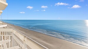 A balcony with a view of the ocean and a clear sky. - Rising Tides Properties Condo 1007 (Murrells Inlet)