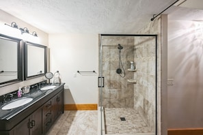 A bathroom with two sinks, a glass shower enclosure, and a towel rack. - Cushing Home Family Cabin Near Wachusett Mtn 4 Bedroom Home (Ashburnham)