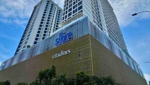 A high-rise building with a prominent 'citadines' sign on the lower level, featuring a modern architectural design with a grid-like facade and a large entrance area.