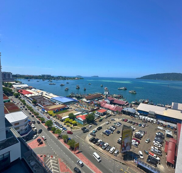 A coastal cityscape with a marina, commercial buildings, and a clear blue sky. - GrandVue Suites The Shore Kota Kinabalu (Kota Kinabalu)