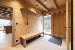 A wooden interior with a bench, a wall-mounted heater, and a door leading outside. - Vysok nad Jizerou Lvta052 (Vysoké nad Jizerou)