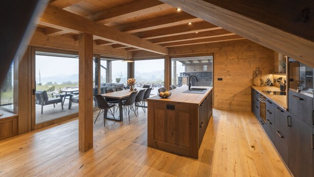 A spacious kitchen with wooden beams, large windows, and a dining area with a view. - Vysok nad Jizerou Lvtu051 (Vysoké nad Jizerou)
