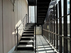 A narrow stairway with metal railings, leading to a covered area with a metal roof. - goom Hotel Nakasu Maxim (Fukuoka)