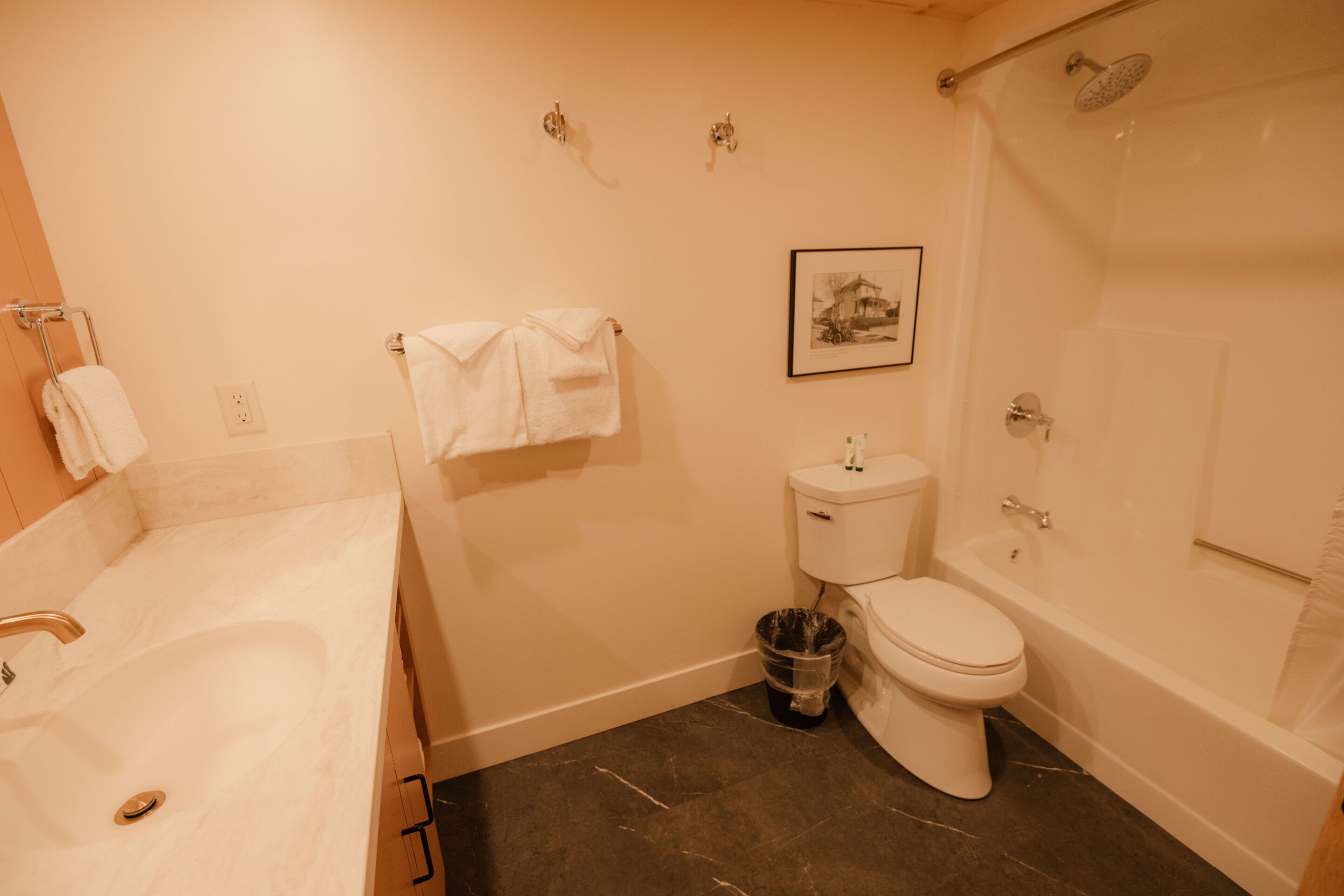 A bathroom with a bathtub, toilet, and sink.