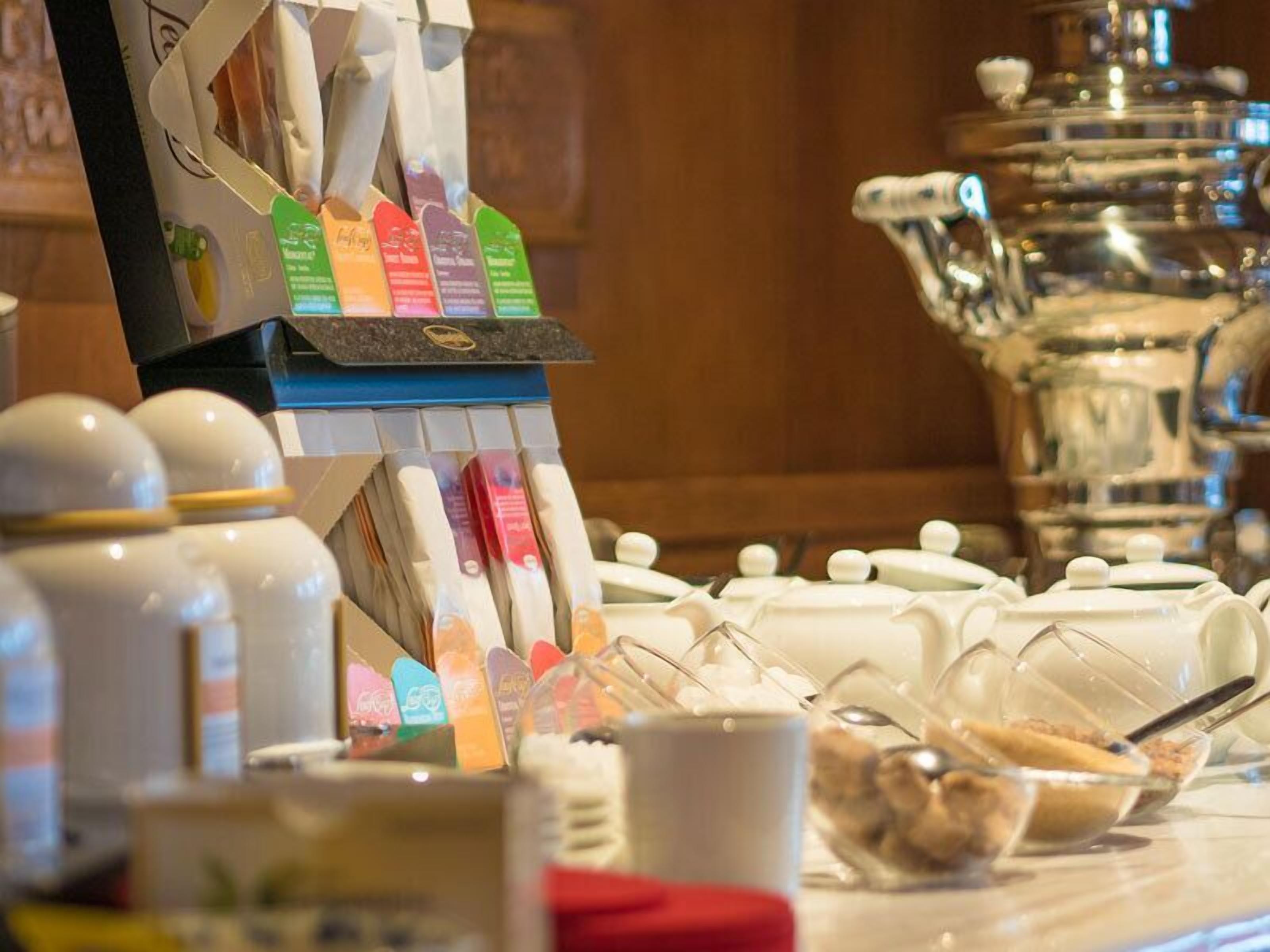 A breakfast buffet with various food items and a coffee station.