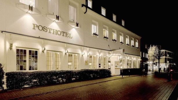 A white building with the sign "POSTHOTEL" and multiple windows, likely a hotel. - Posthotel Monegro  (Steinfurt)