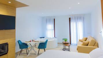 Comfort Studio | Living area | 50-inch Smart TV with digital channels, fireplace, Netflix