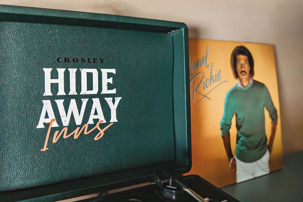 Ein grünes Buch mit dem Titel 'Crosley Hide Away Inns', das ein Männerporträt auf dem Einband zeigt.