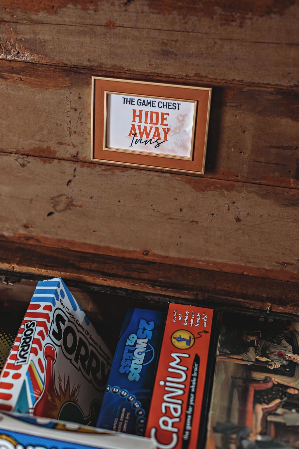 A wooden chest with a sign that reads "The Game Chest Hide Away Inns."