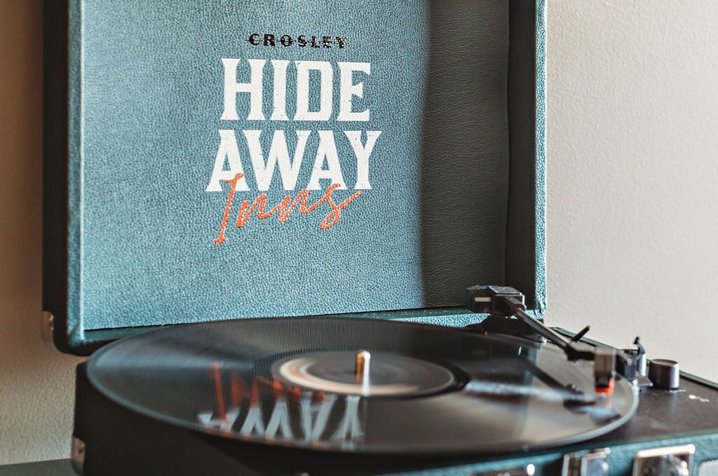 A vintage Crosley turntable with a blue case labeled "HIDE AWAY" and "Fingers."