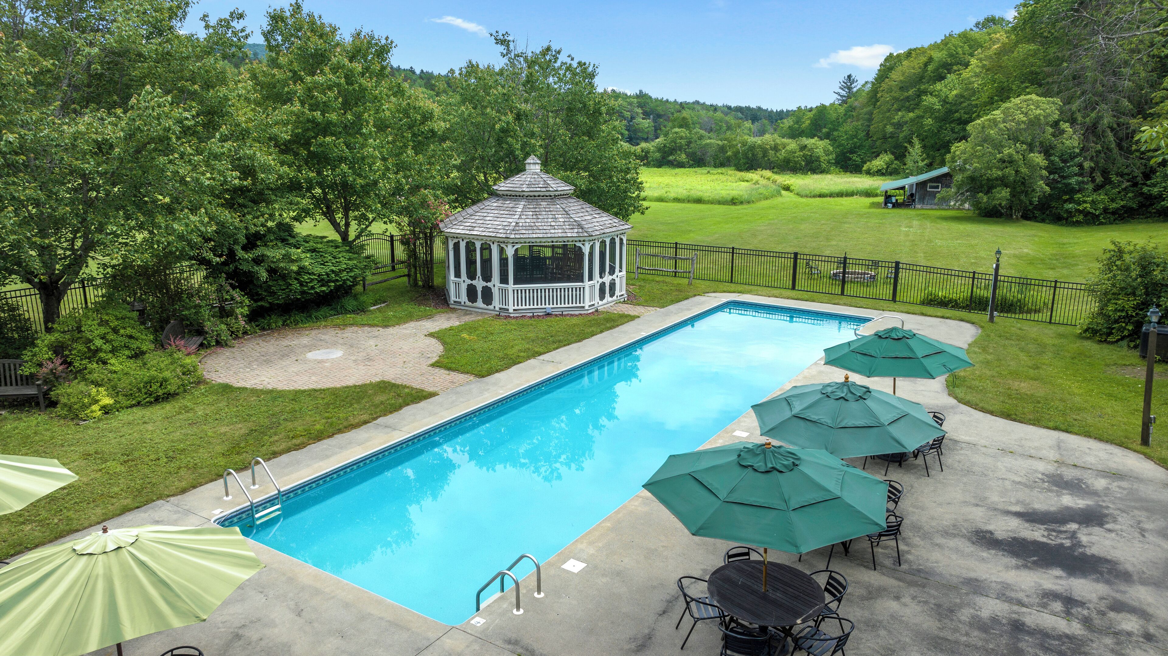 Seasonal outdoor pool, open 10:00 AM to 8:00 PM, pool umbrellas