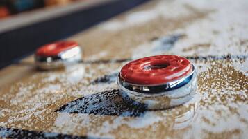 A close-up of a car's steering wheel with a red cover.