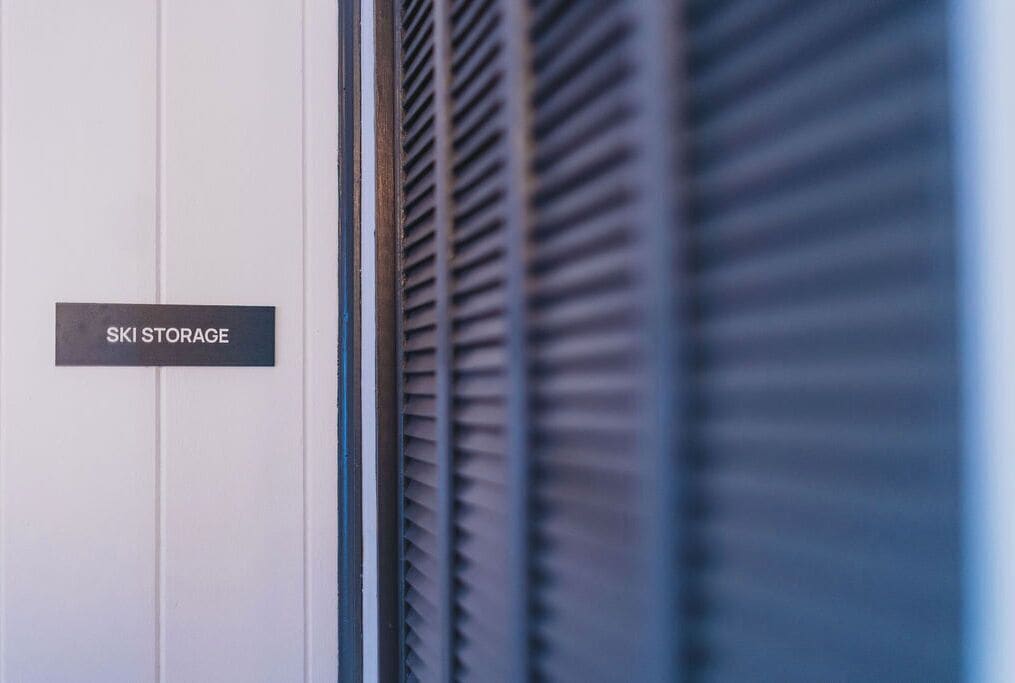 A sign labeled "SKI STORAGE" on a white door.