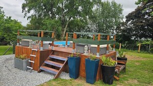 A wooden deck with a pool, steps, and planters. - The Lions Den - La Loge Mantilly (Mantilly)